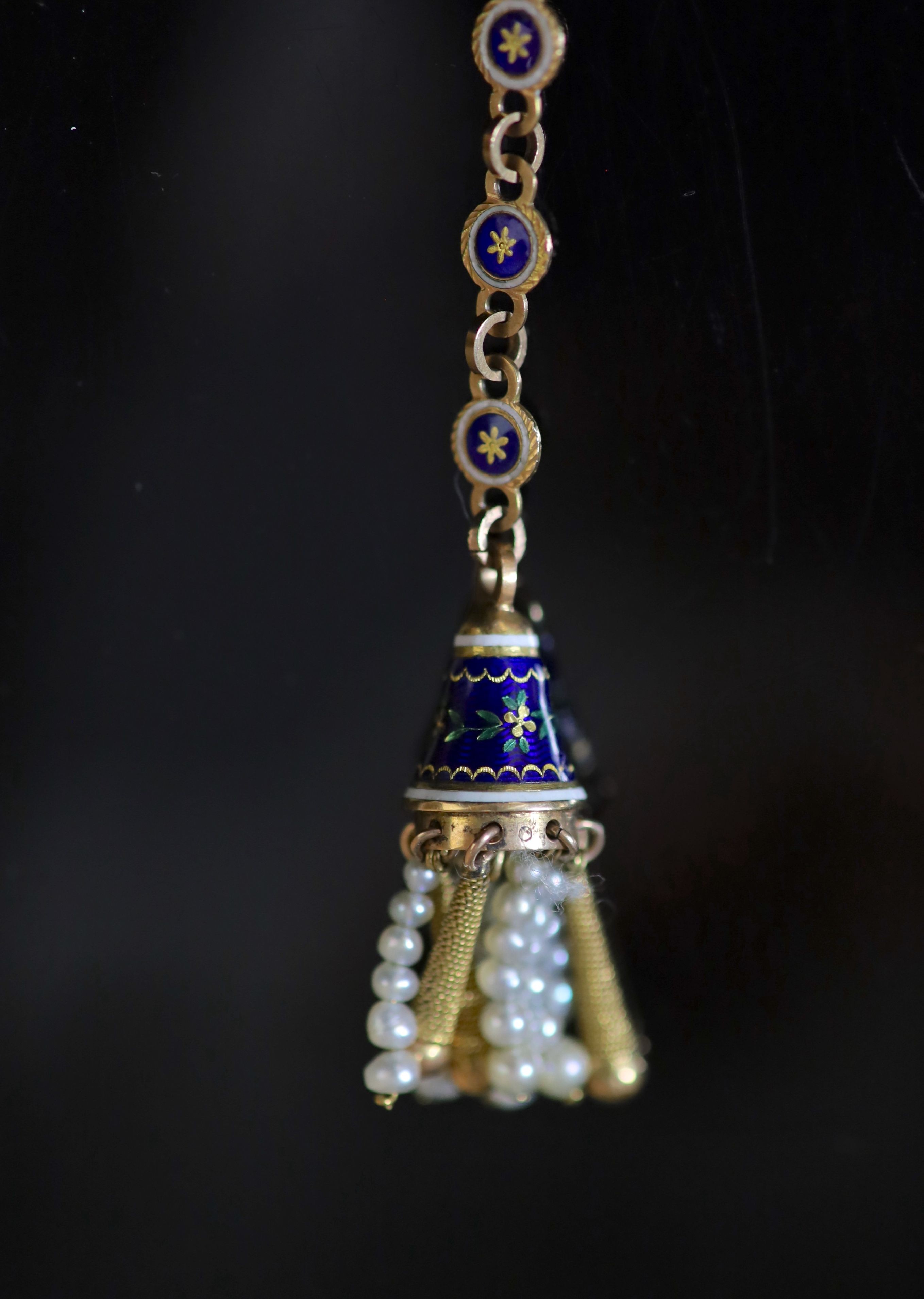 An early 19th century French or Swiss gold and enamel chatelaine, hung with eleven assorted accoutrements